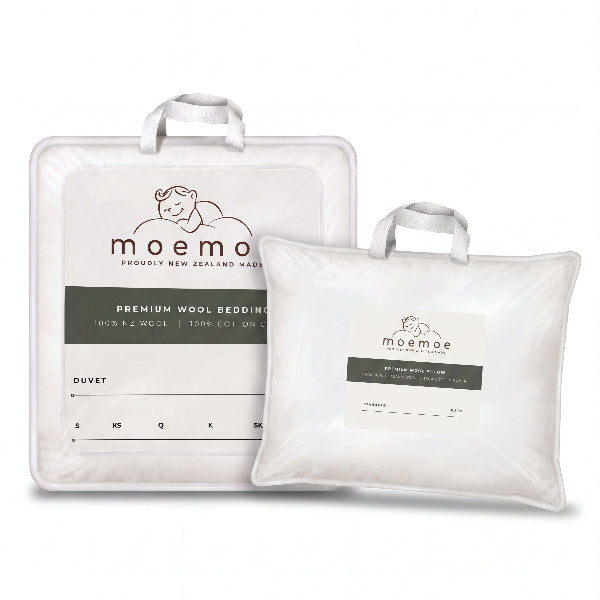 Two white Moemoe brand bedding items on a clean white background: a larger duvet in a square white storage bag and a smaller pillow in a rectangular white bag. Both bags have handles and printed labels with the Moemoe logo and product text.